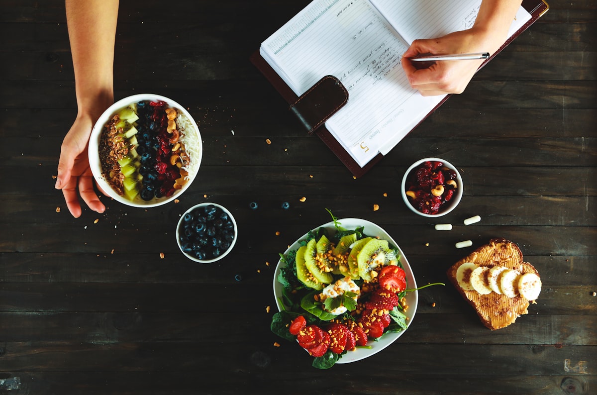 Nutritionist working with meal plans and fresh vegetables